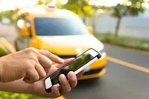 person holding phone. Is your business at risk from the Uber decision? Why your self-employed contractors could really be employees