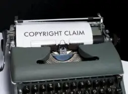 typewriter with text on paper saying copyright claim