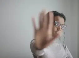 Worker holding hand up. The Legal Director
